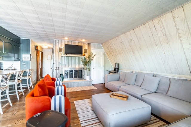 living room featuring wooden walls and hardwood / wood-style floors