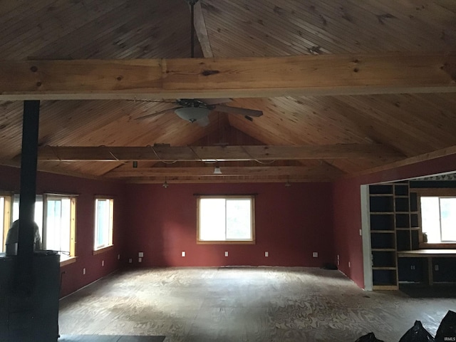 unfurnished living room featuring ceiling fan, vaulted ceiling with beams, and wood ceiling