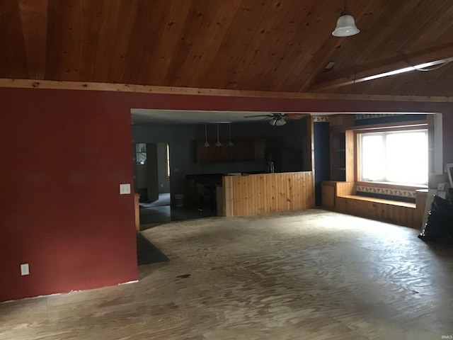 unfurnished living room with lofted ceiling, wood-type flooring, wood ceiling, and ceiling fan