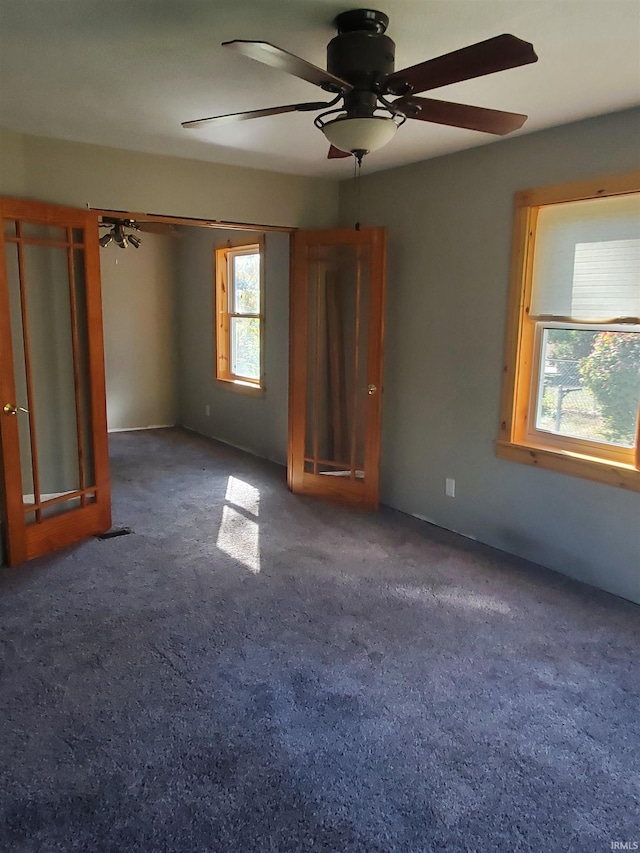 interior space featuring ceiling fan and carpet flooring