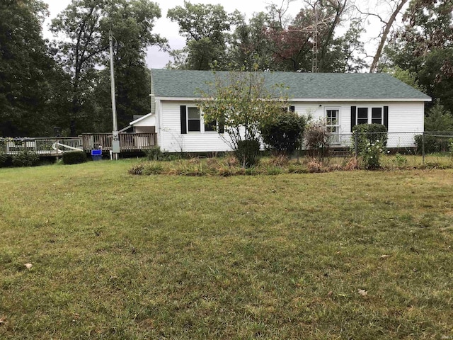 view of front of house featuring a wooden deck and a front lawn