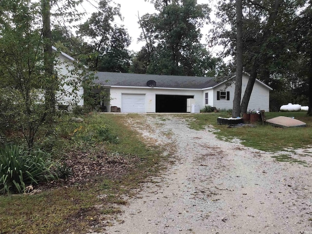 ranch-style home featuring a garage