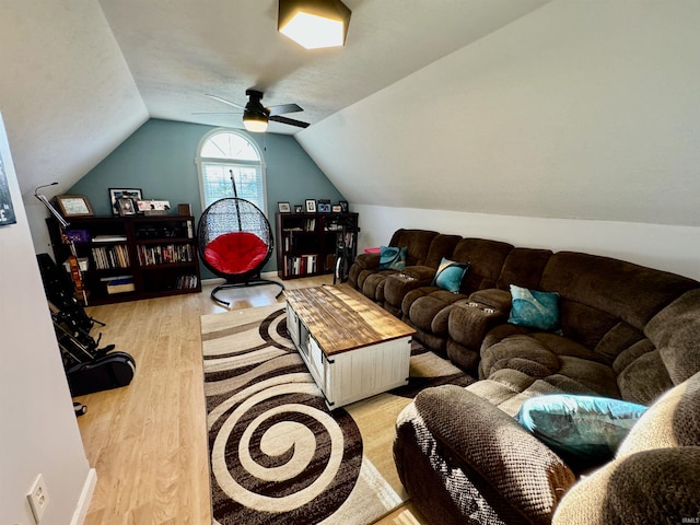 living room featuring light wood-type flooring, vaulted ceiling, and ceiling fan