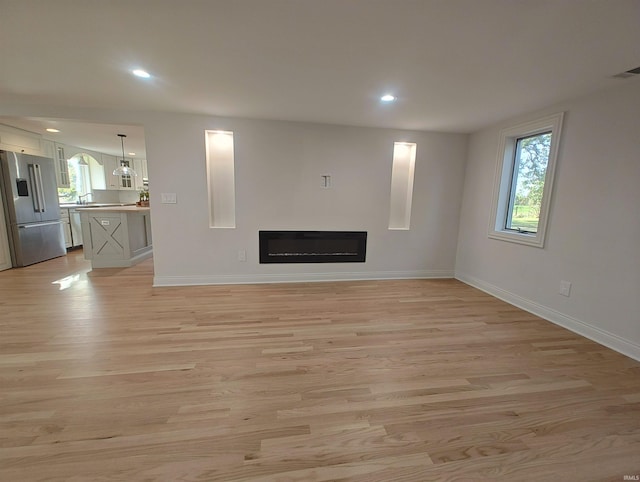 unfurnished living room featuring light hardwood / wood-style floors