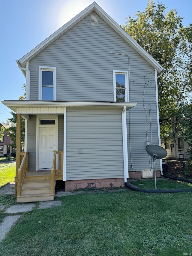 rear view of property with a yard