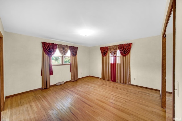 unfurnished room with hardwood / wood-style flooring