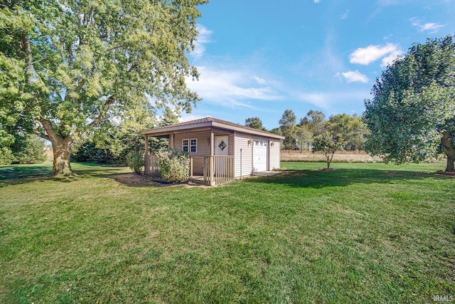 view of yard with a garage and an outdoor structure