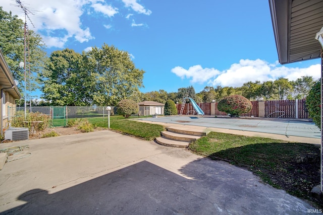 view of yard with a playground, cooling unit, and a patio