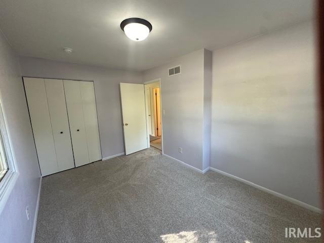 unfurnished bedroom featuring a closet and carpet