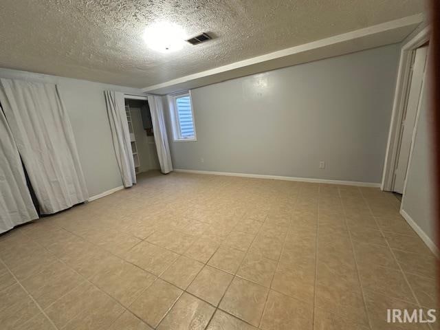 unfurnished bedroom with a textured ceiling