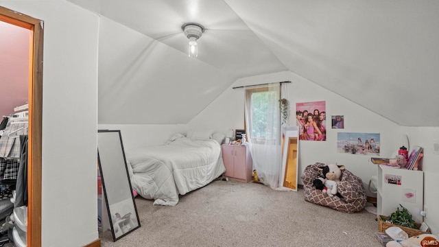 carpeted bedroom with lofted ceiling