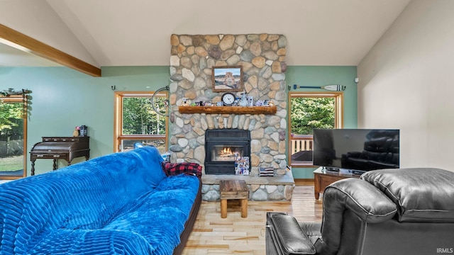 living room featuring lofted ceiling, a fireplace, and hardwood / wood-style floors