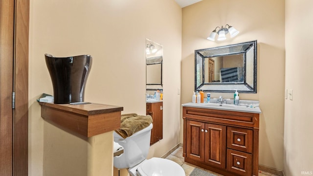 bathroom with vanity, tile patterned flooring, and toilet