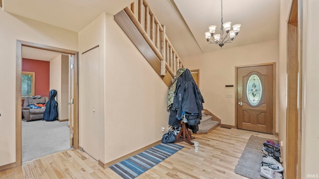 foyer featuring light hardwood / wood-style floors and a chandelier