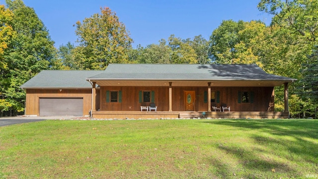 ranch-style home featuring a front yard, a garage, and a porch