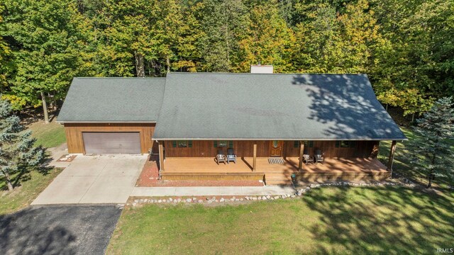 view of front facade with a front lawn, a porch, and a garage