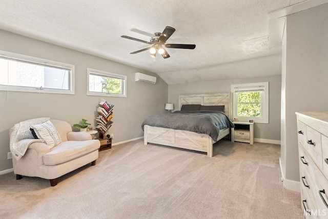 bedroom featuring lofted ceiling, ceiling fan, a wall mounted air conditioner, and light colored carpet