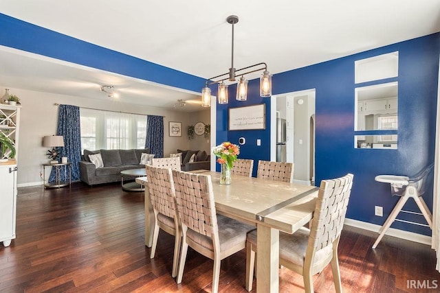 dining space featuring dark hardwood / wood-style flooring