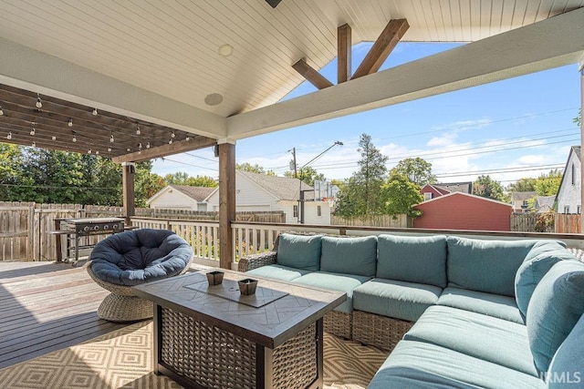 wooden terrace with an outdoor hangout area