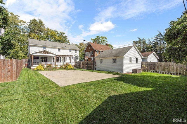 back of property with a lawn, a patio area, and central AC