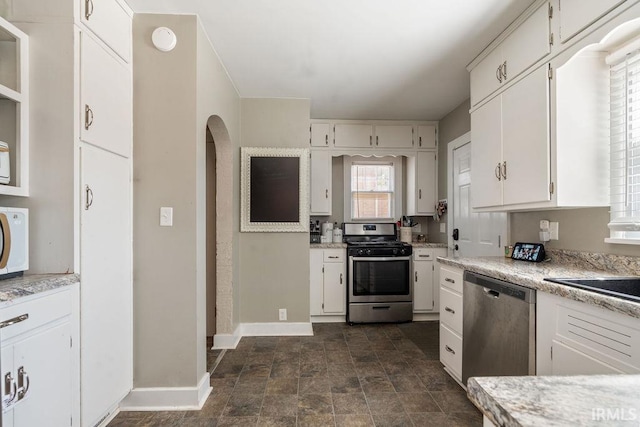 kitchen featuring stainless steel appliances and white cabinetry