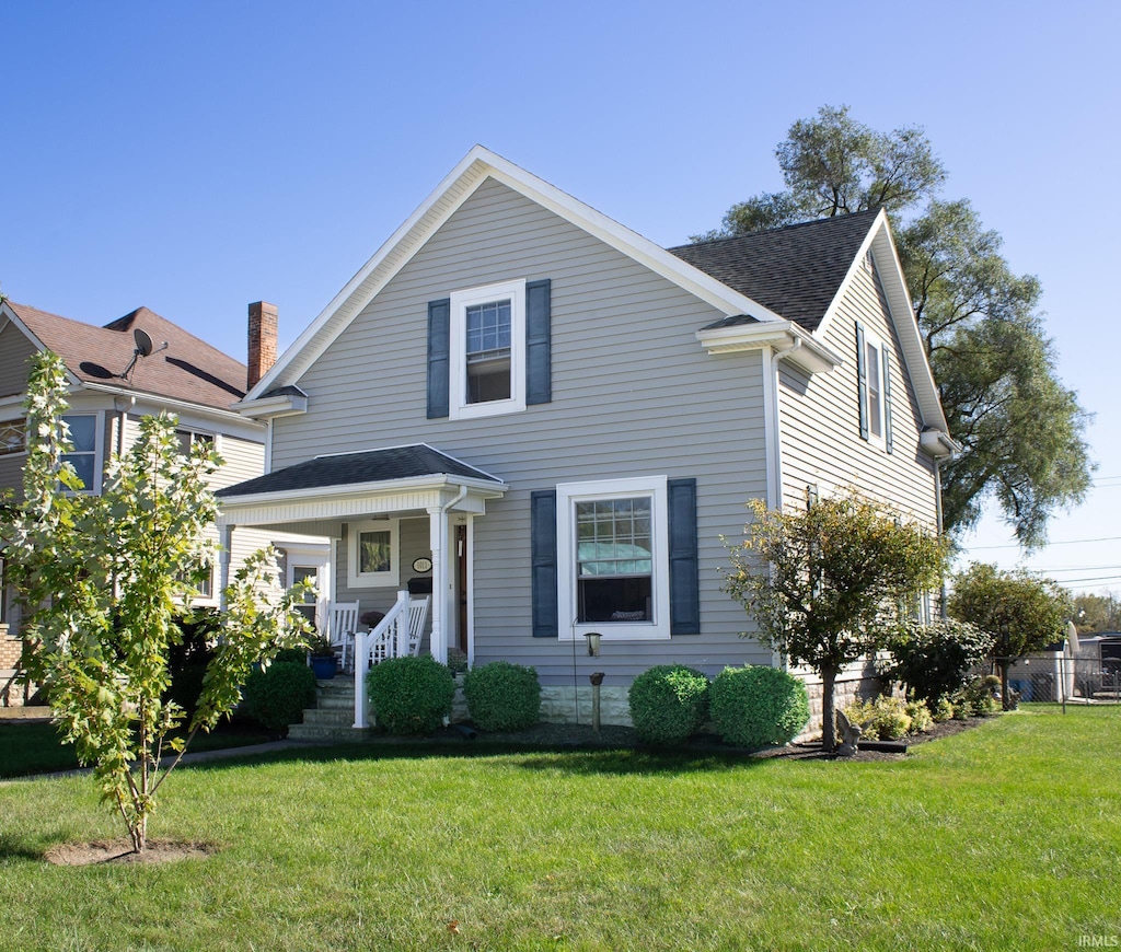 view of front of house featuring a front lawn and covered porch