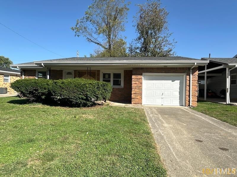 ranch-style house featuring a garage, cooling unit, and a front lawn