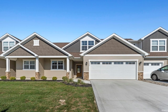 craftsman inspired home with a front lawn and a garage