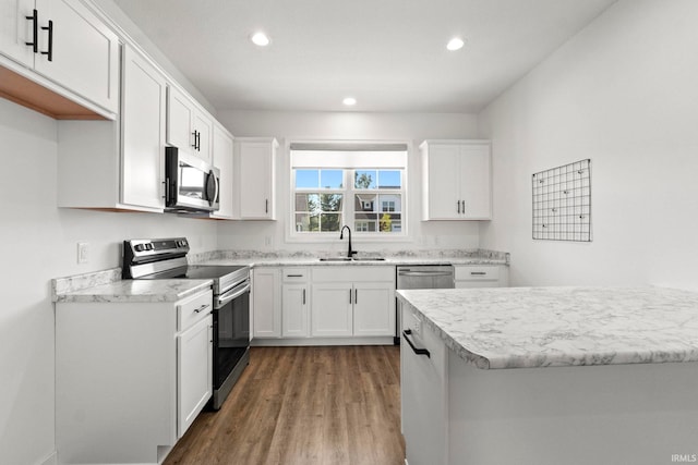 kitchen with white cabinetry, sink, stainless steel appliances, and dark hardwood / wood-style flooring