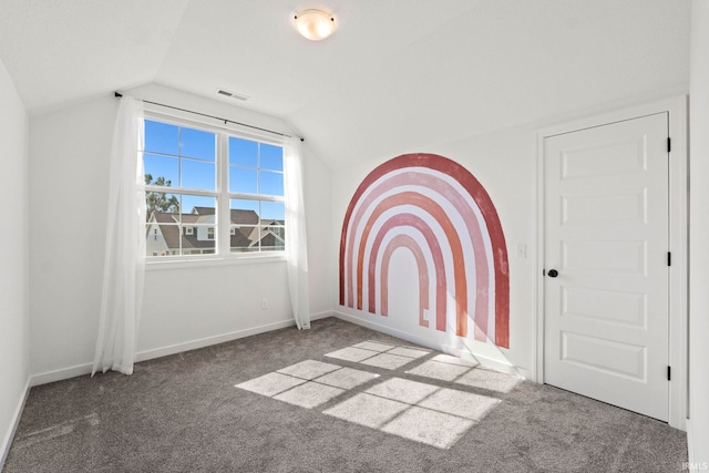 interior space with vaulted ceiling and carpet