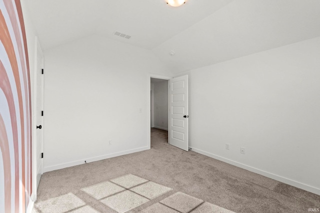 unfurnished bedroom featuring lofted ceiling and light carpet