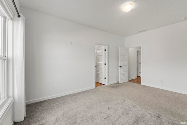 unfurnished bedroom with light carpet