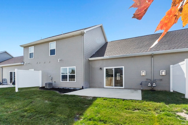 rear view of house featuring a lawn and a patio