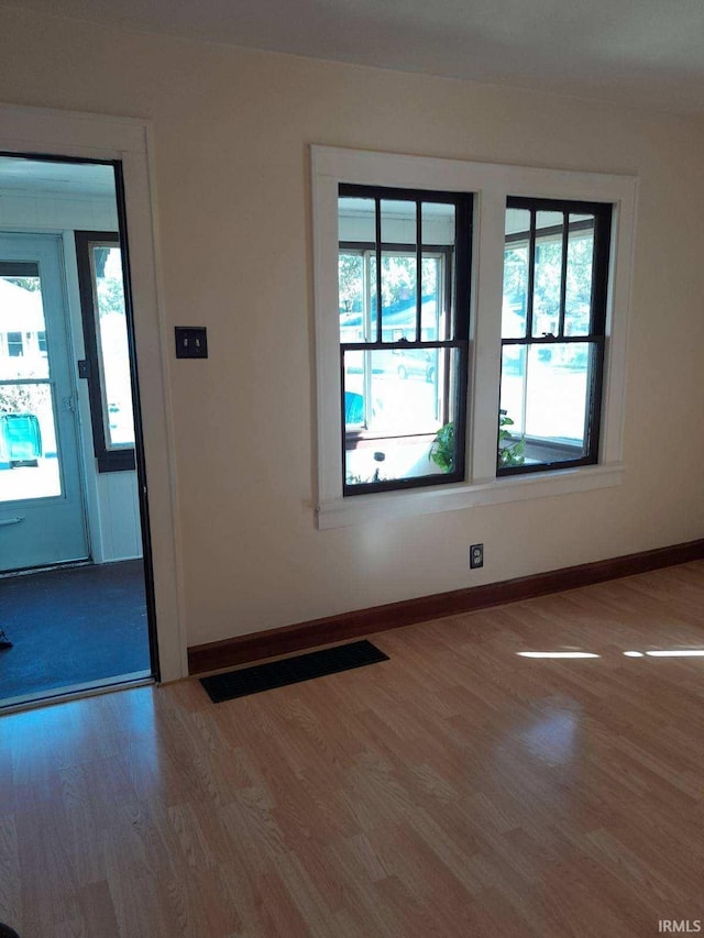 unfurnished room featuring hardwood / wood-style floors