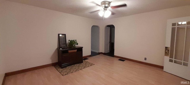 interior space with ceiling fan and wood-type flooring