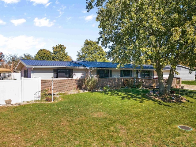 ranch-style home featuring a deck and a front yard