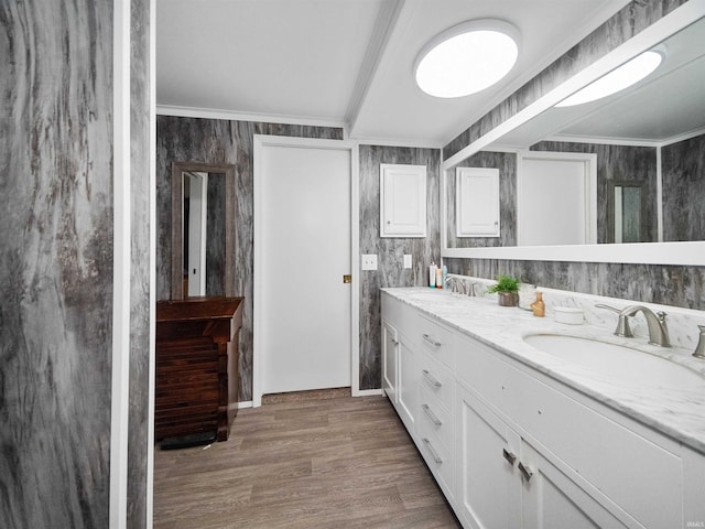 bathroom featuring ornamental molding, vanity, and hardwood / wood-style floors