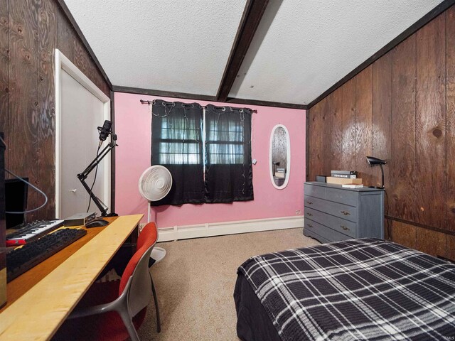 bedroom with a textured ceiling, wooden walls, and a baseboard heating unit