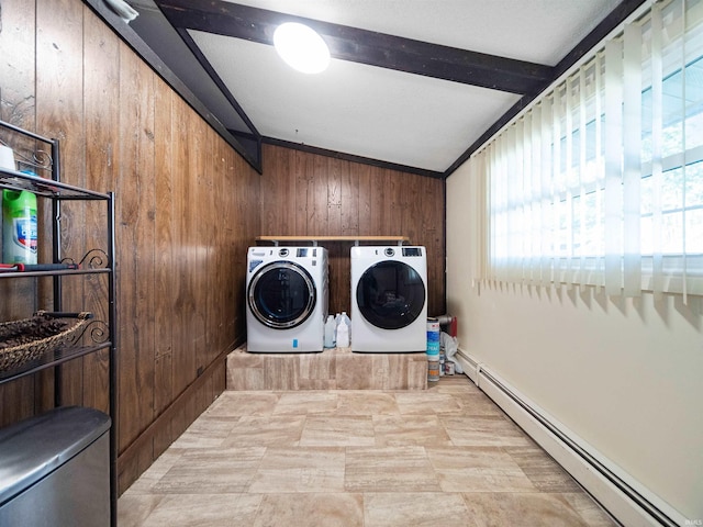 washroom featuring washer and clothes dryer, a baseboard radiator, wood walls, and crown molding