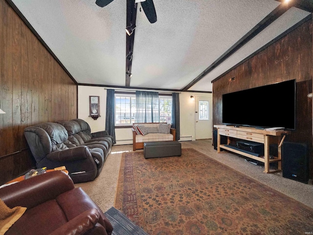 living room with wood walls, beam ceiling, and a textured ceiling