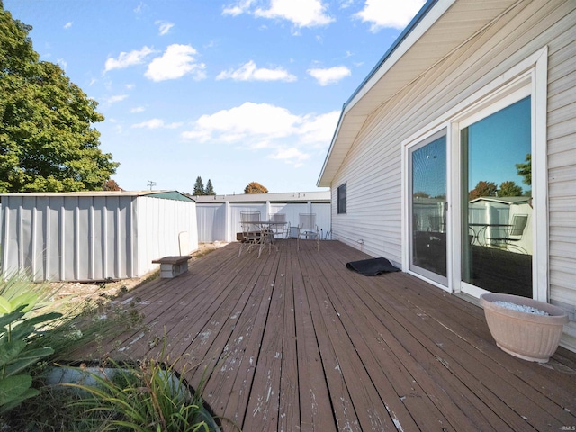 wooden terrace with a shed