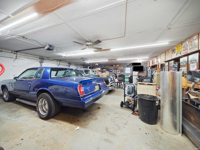 garage with ceiling fan and a garage door opener