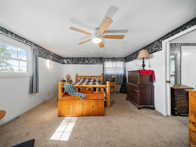 bedroom with ceiling fan and light carpet