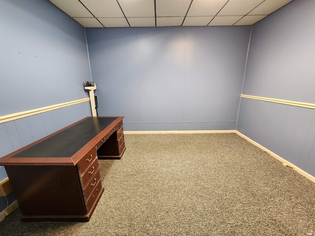 interior space featuring a paneled ceiling and carpet flooring