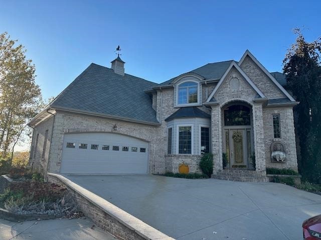 french country inspired facade with a garage