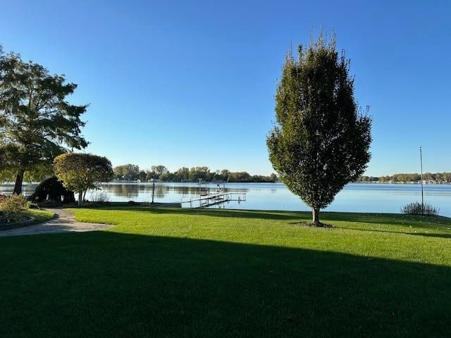 view of community with a yard and a water view