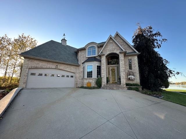 french country style house with a garage