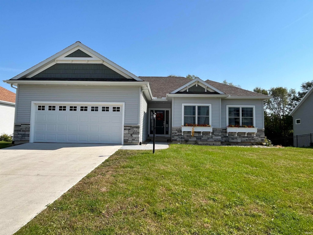 craftsman-style house featuring a front yard and a garage