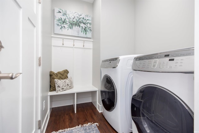 laundry room with washer and dryer and dark hardwood / wood-style floors