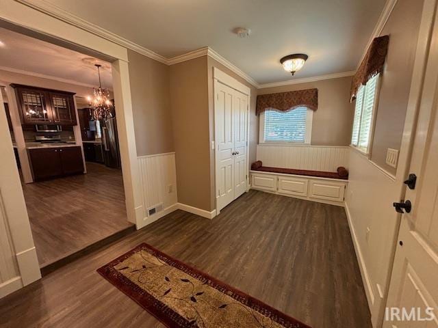 mudroom featuring ornamental molding, a chandelier, and dark hardwood / wood-style flooring